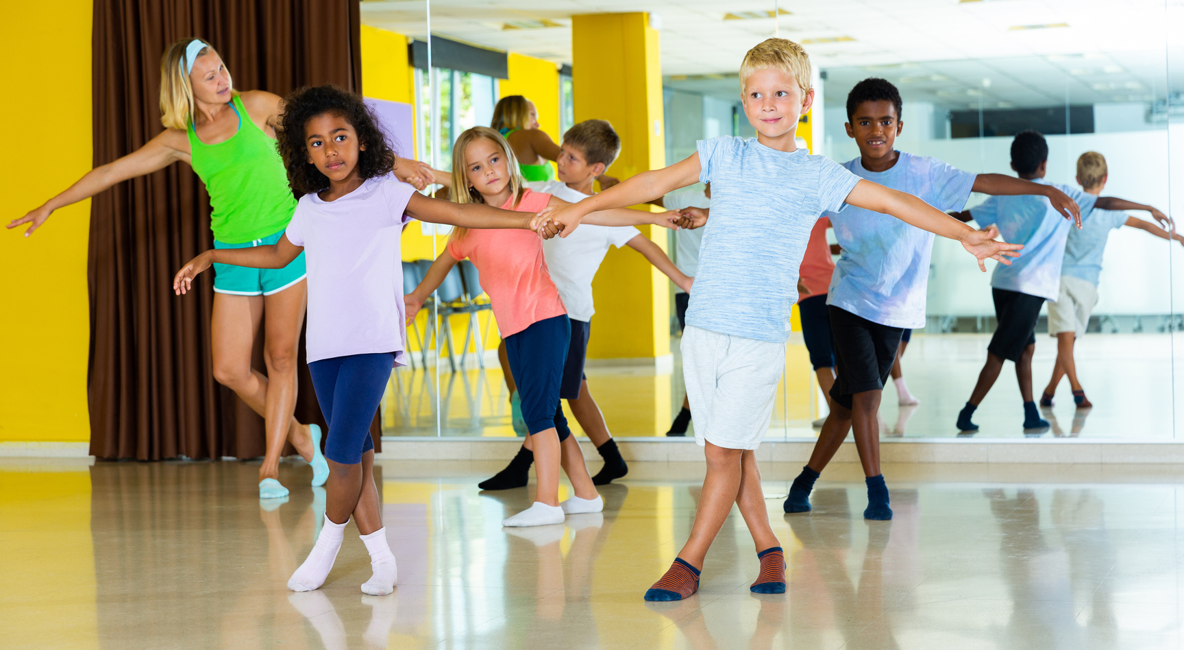 Children learn dance movements in dance class